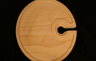 CNC-routed wooden plate with a precision-cut cup holder slot, available in bulk for manufacturers.